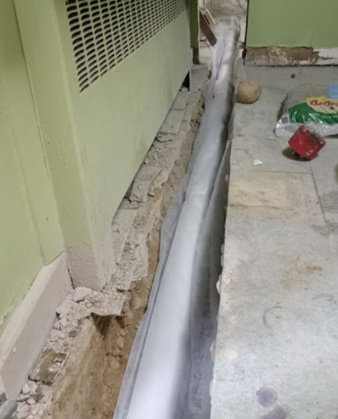 Foundation Repair Contractors in Borough Park, NY - A Foundation Waterproofing Project by Zavza Seal Showing a French Drain Installation About Halfway Finished<br />
