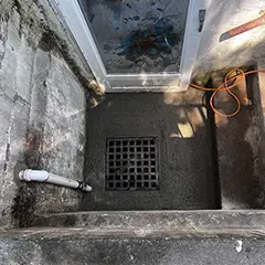 Water damage restoration with drain installation containing a sump pump 