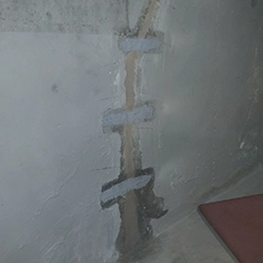 A repaired vertical crack with epoxy and then sealed with a basement waterproofing solution  After