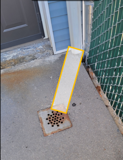 A faulty gutter downspout in need of repair work