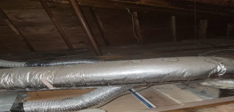 The attic area in the property in Lake Grove, NY was in desperate need of insulation and air sealing. The old worn-out insulation can be seen.