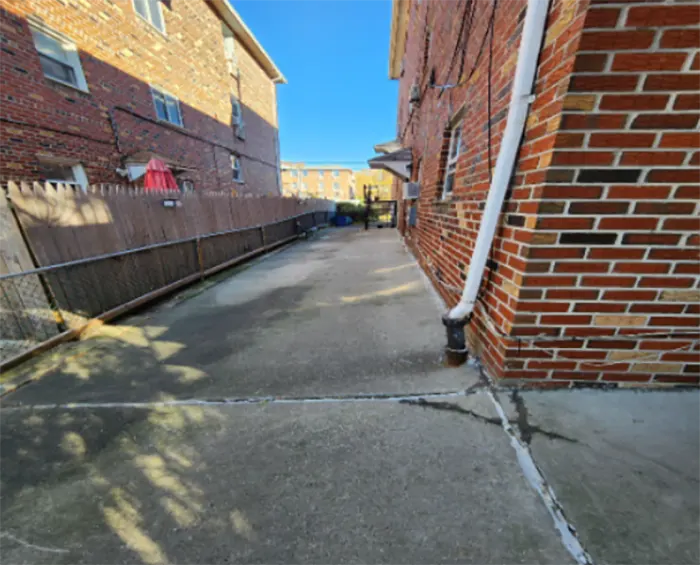 The cracked driveway with sinking issues because of soil displacement. 