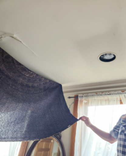 The damaged section of the ceiling in the living room that was in need of repairs