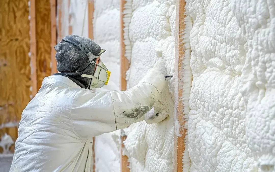 Contractor installing spray foam insulation in the attic of a house