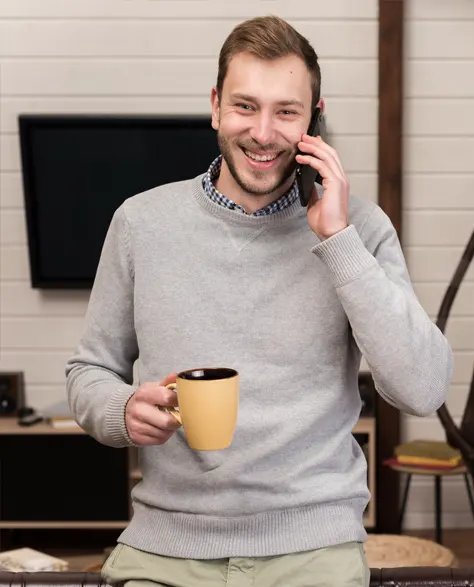 A homeowner talking on the phone to book a dual sump pump system installation