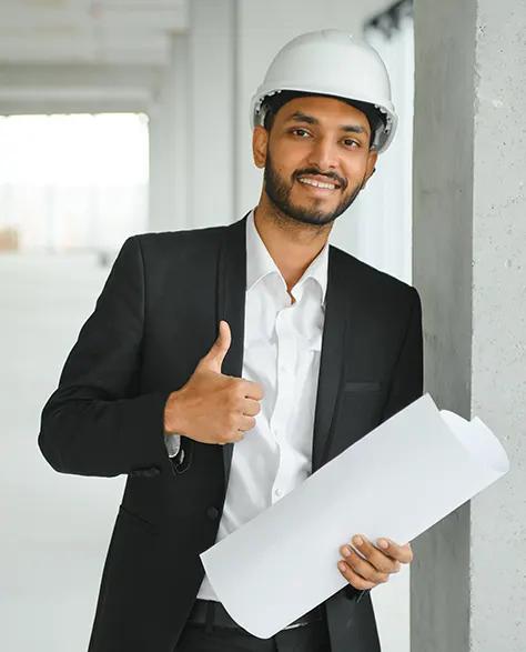 a happy construction manager in a hard hat giving a thumbs up 