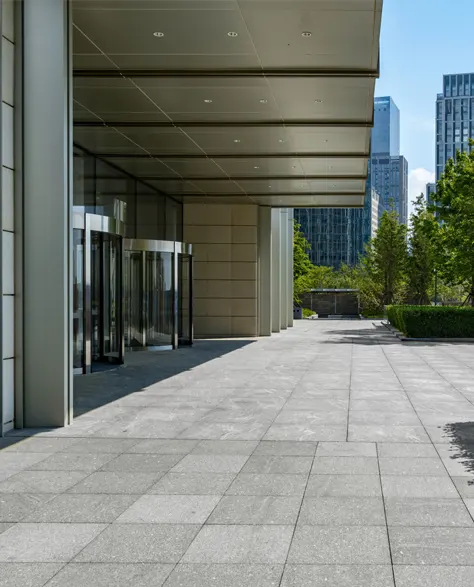 A sidewalk under a modern building in Brooklyn