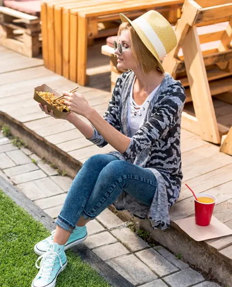 A woman sitting on her patio after a successful concrete raising of her patio pavers