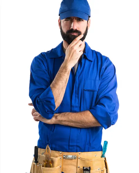 A worker in blue overalls and a tool belt thinking about the project 