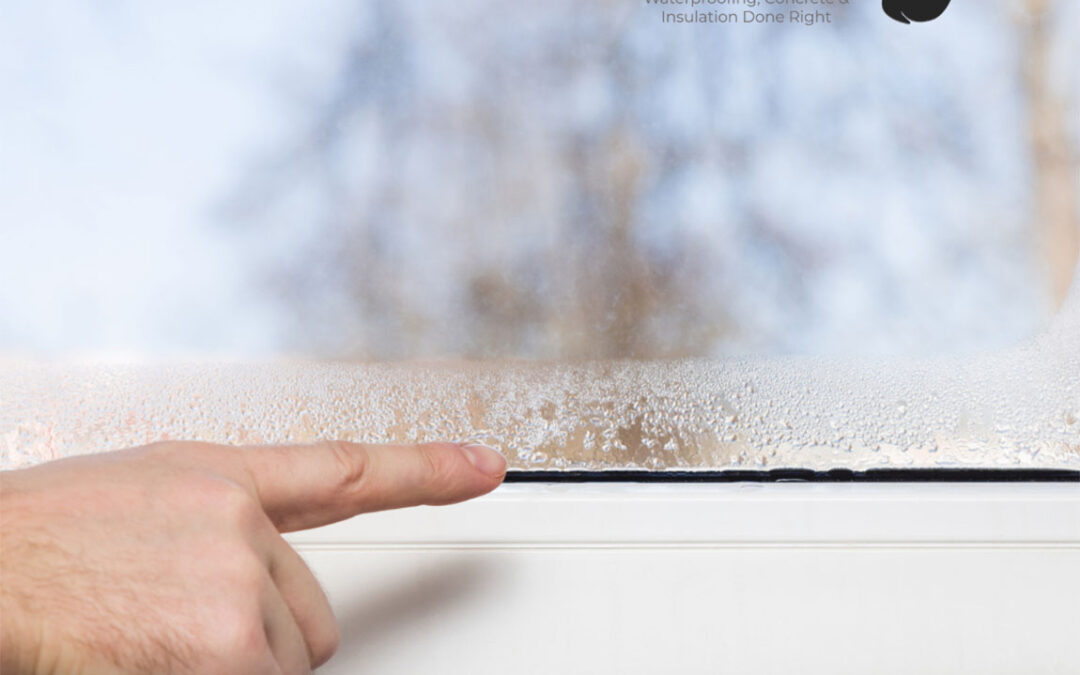 Closeup shot of man’s finger pointing to condensation on a window overlooking trees