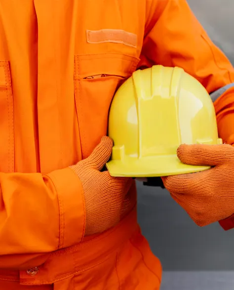 A contractor holding a hard hat in his hand.