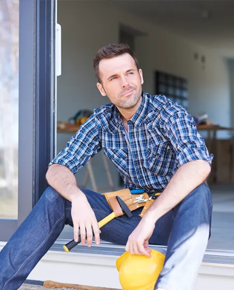 A contractor sitting on the front porch of a house<br />
