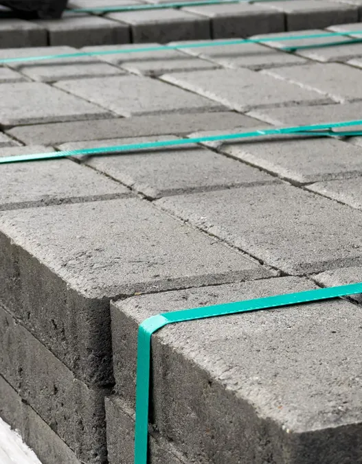 Neatly stacked concrete pavers for a deck on top of one another