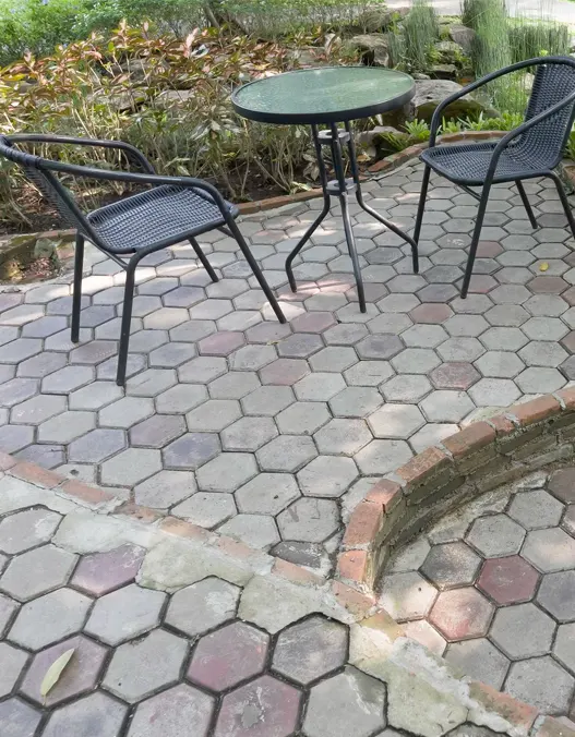 Paver Deck Installation: two chairs and a table neatly situated on a paver deck.