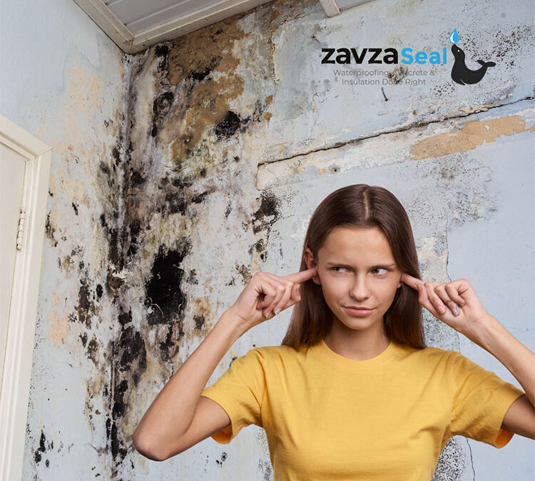 Woman in a yellow shirt with her back turned ignoring the black mold infestation on her wall