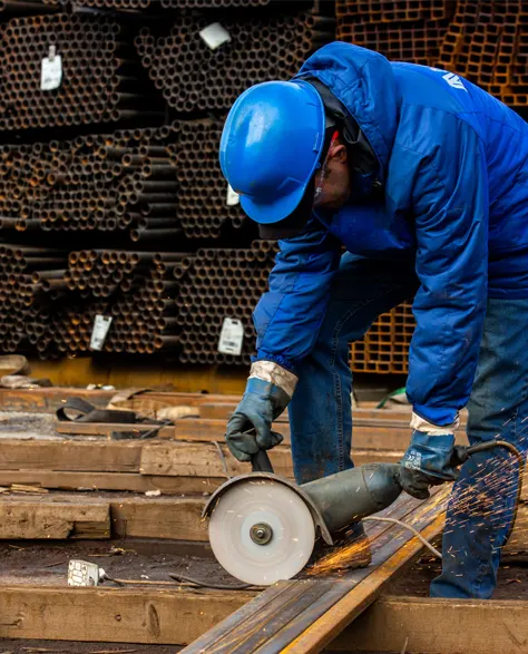 A construction worker constructing a helical pier made of metal