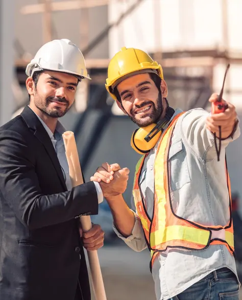 A contractor and a construction worker shaking hands