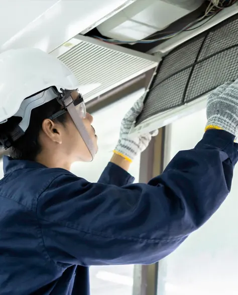 A contractor checking the filter of an HVAC system