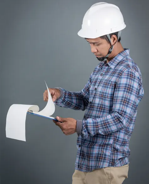 A contractor conducting a routine check on a reinforced foundation wall.