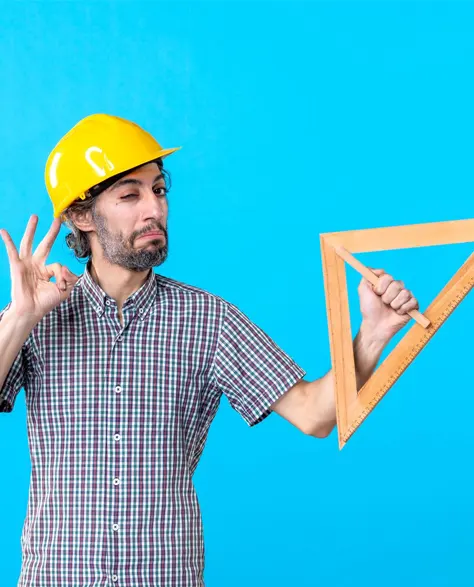 A contractor in a hard hat and holding a balance tool 