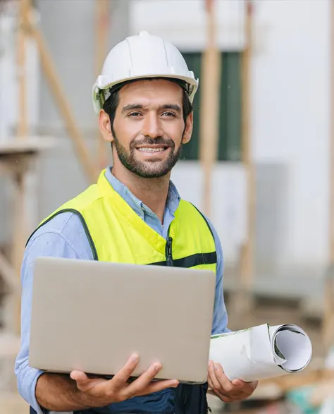 A close-up of a professional contractor in a hard hat and holding a blue print in his arm