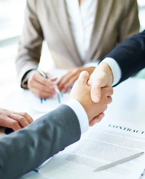 A handshake between two men in business suits in an office in Zavza Seal LLC