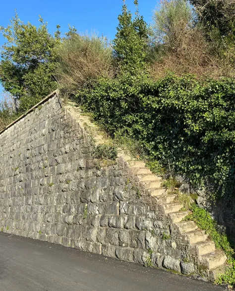 A partial retaining wall on the roadside.