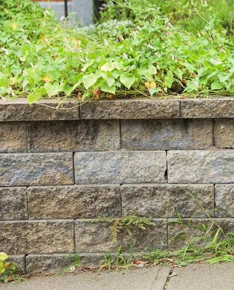 Retaining Wall Installation: A retaining wall made up of stone in a neighborhood in New York.