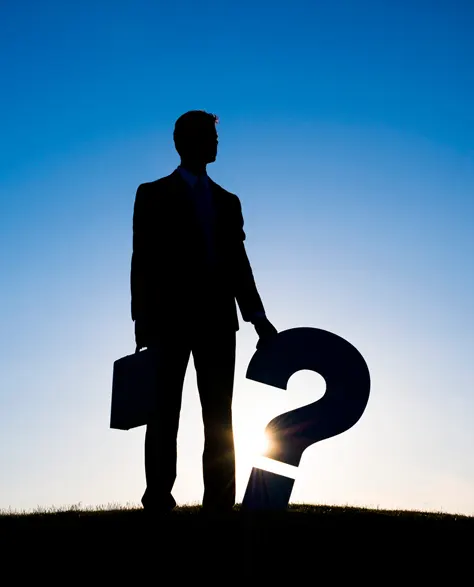 A silhouette of a professional holding a question mark