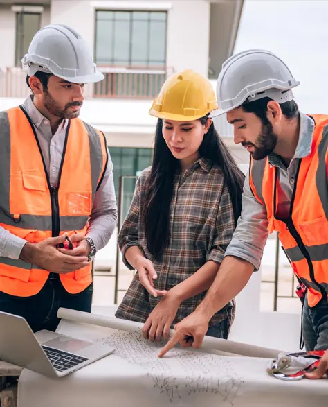 A team of contractors reading blueprints