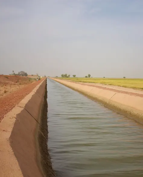 A water channel in the outskirts of a town