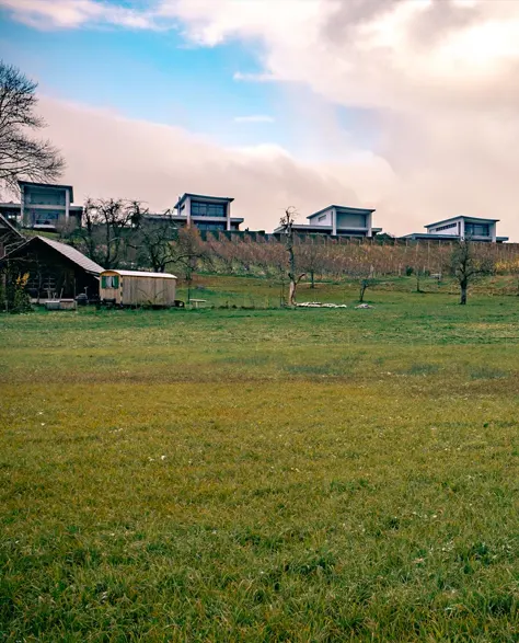 An open yard with houses and their retaining walls.