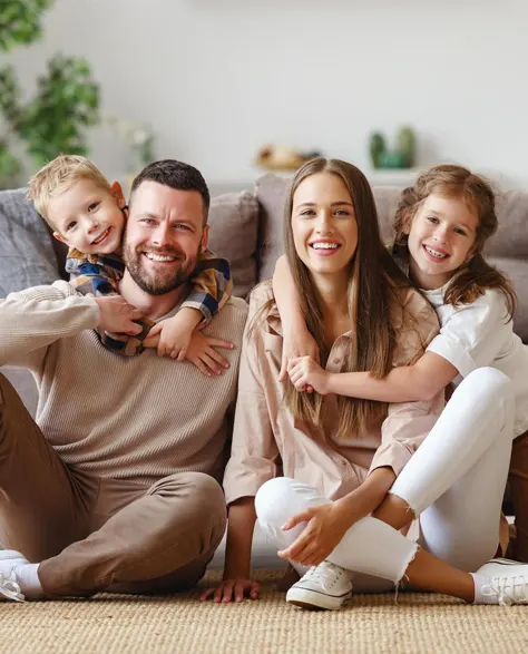 A happy family in their warm and insulated home that they got from rebates from National Grid.