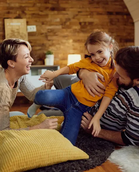 A happy family in their warm and insulated home that they got from rebates from PSEG.