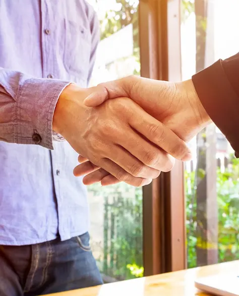 A homeowner who is getting a rebate from Con Edison shaking hands with a zavza seal expert.