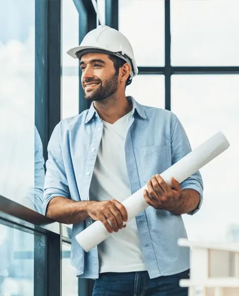 A contractor holding a blue print in an office setting.