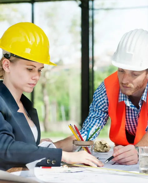 Two contractors discussing moisture control solutions for a project.