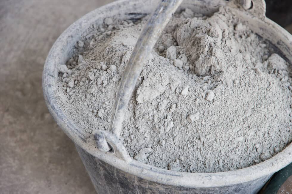 Dry concrete powder in a bucket.
