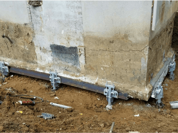 Basement Structural Support - Helical Piers Holding up a Foundation Near a Side with Tipping Settlement