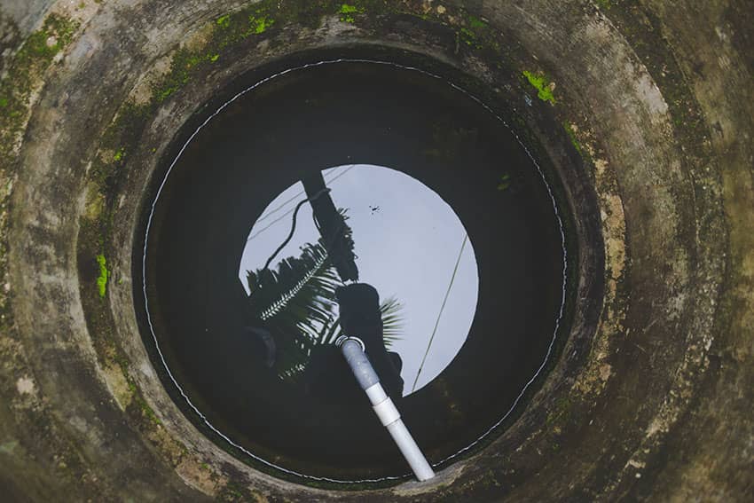 A well with a partial amount of water that needs repair work.