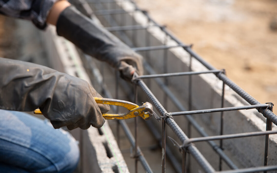 A contractor fixing the steel reinforcement on concrete structures at a construction site