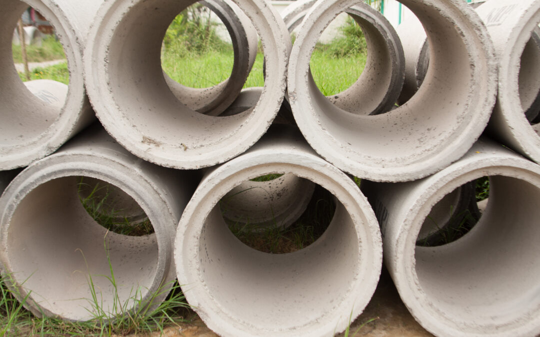 Reinforced concrete pipes stacked on top of each other.
