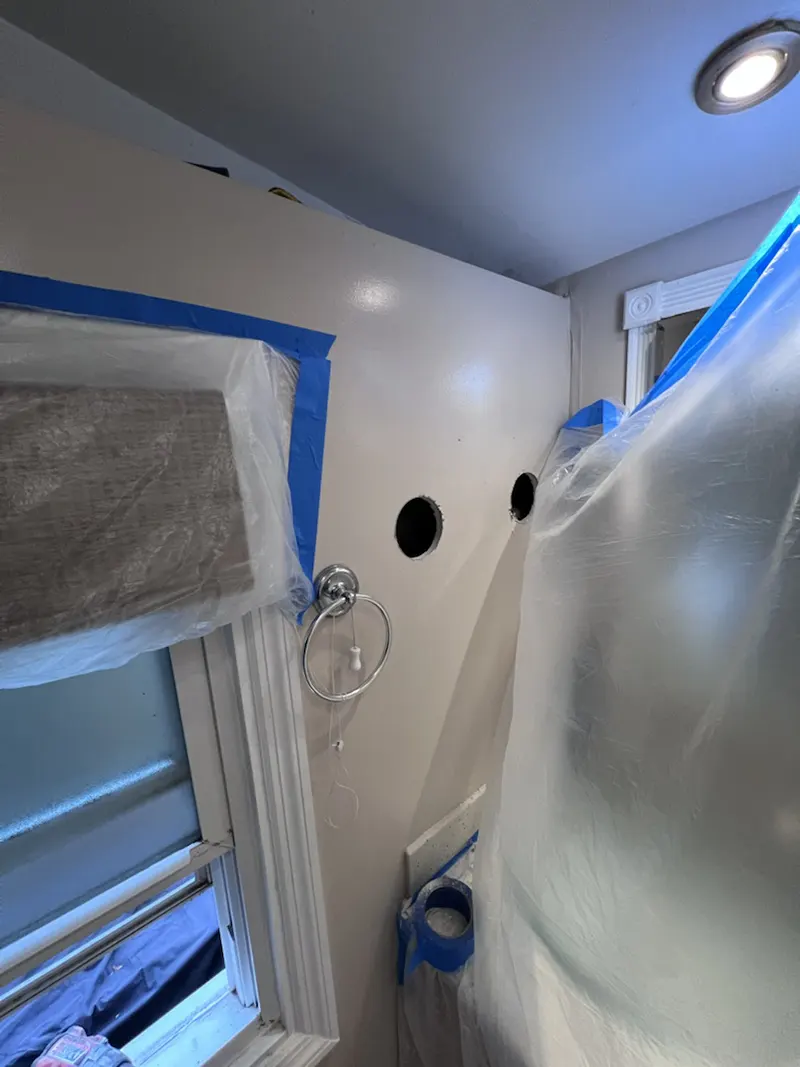 Holes drilled in the wall of the bathroom for insulation purposes. 
