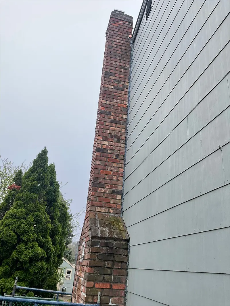 The chimney of the property in North Bellmore, NY in need of waterproofing and stabilization that was successfully repaired by the zavza seal team.