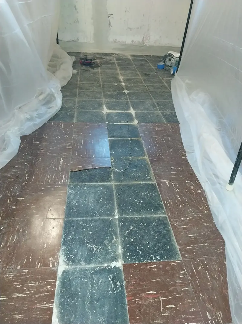The broken, damaged, and leaking concrete slab in need of structural crack repair in Port Jefferson Station, NY.