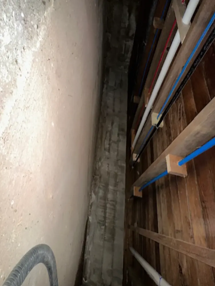 The crawl space in need of waterproofing in Westbury, NY.