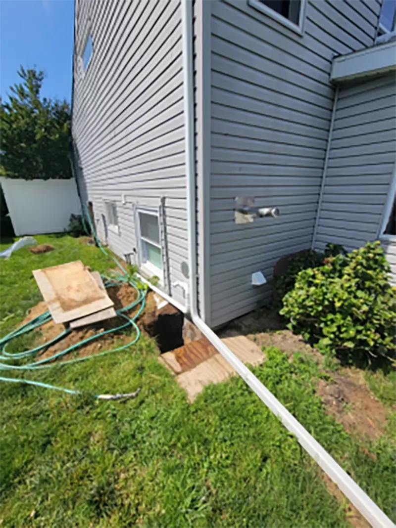 Exterior foundation waterproofing in progress in the property in Sayville, NY