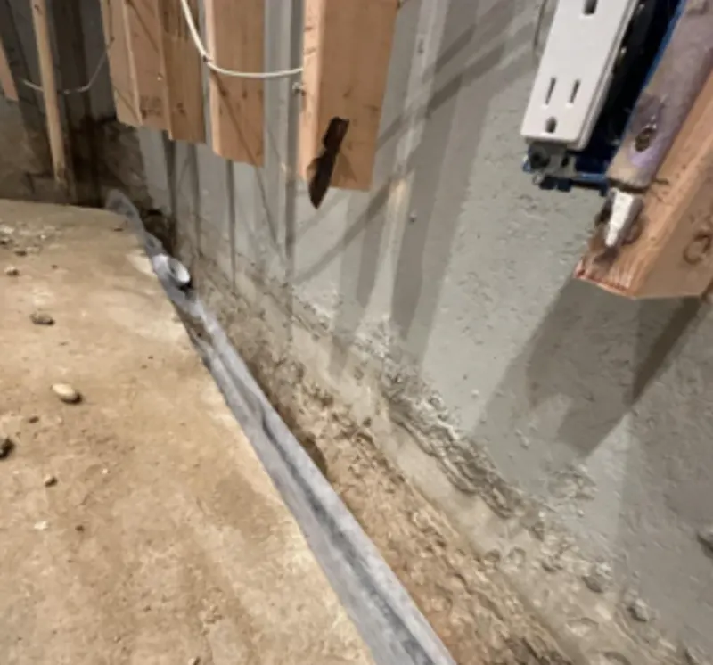 Foundation footing that is in the process of being waterproofed