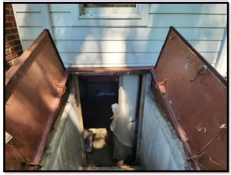 The old bilco door and the staircase in need of maintenance work