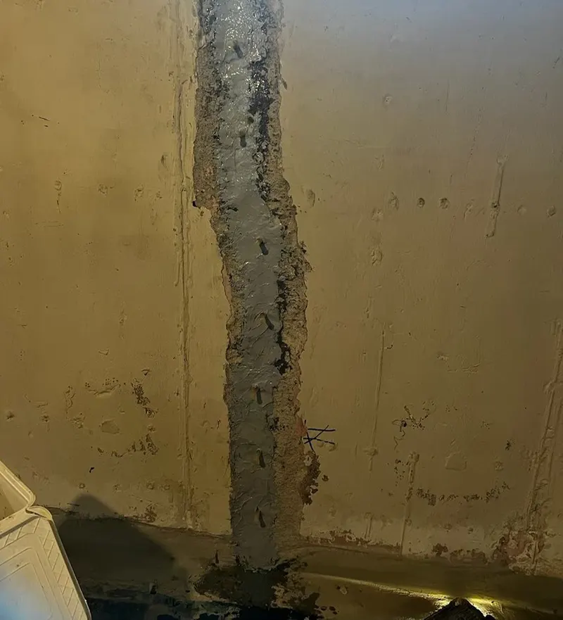 Crack stitching with carbon fiber straps and waterproofing cement on top of the crack